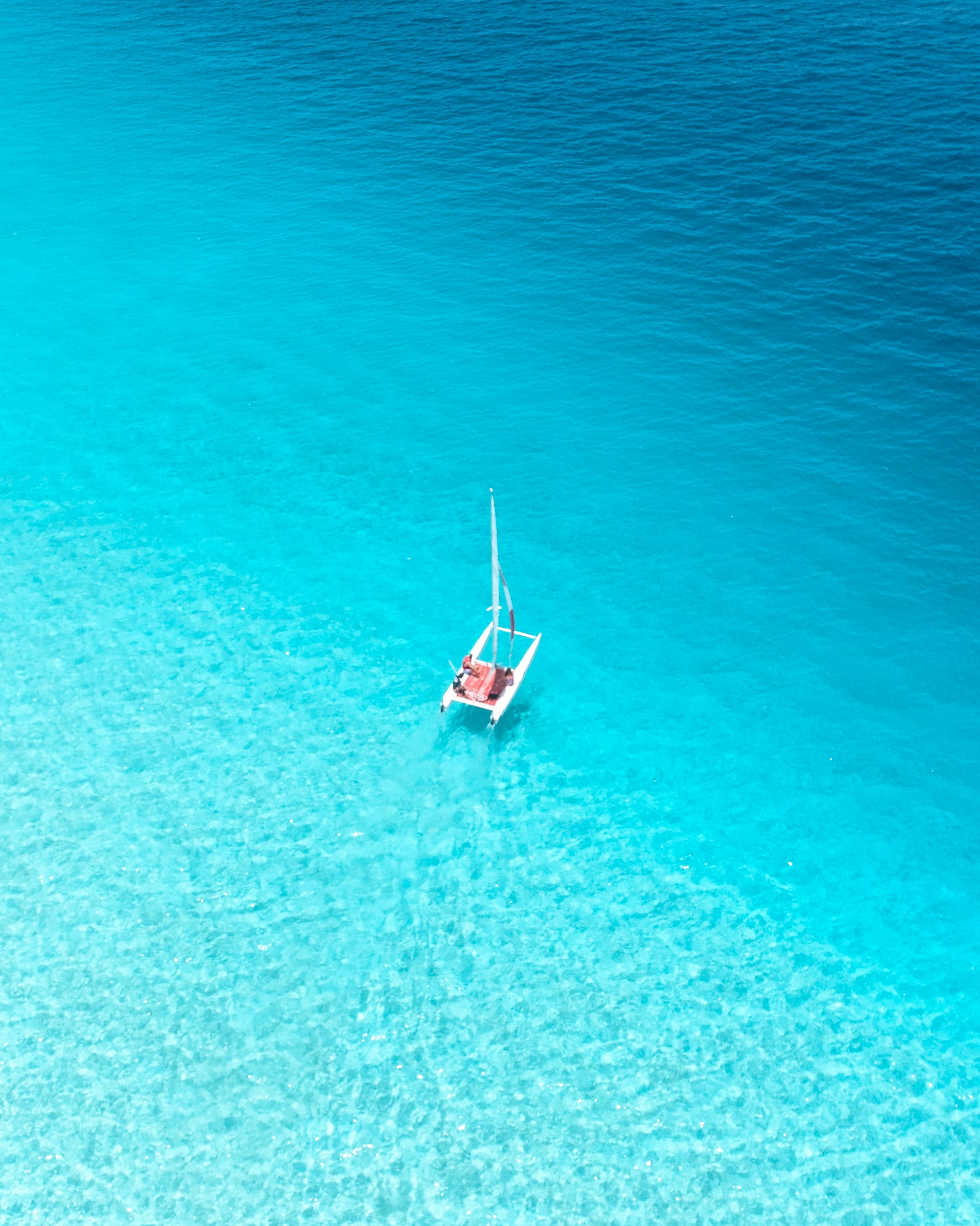 aerial view photography of sailboat on body of water